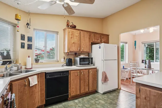 a kitchen with a sink a refrigerator and a stove