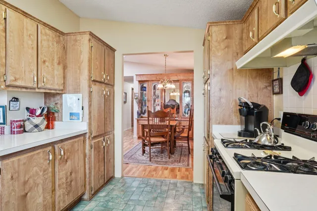 a kitchen with stainless steel appliances a stove a sink and a refrigerator