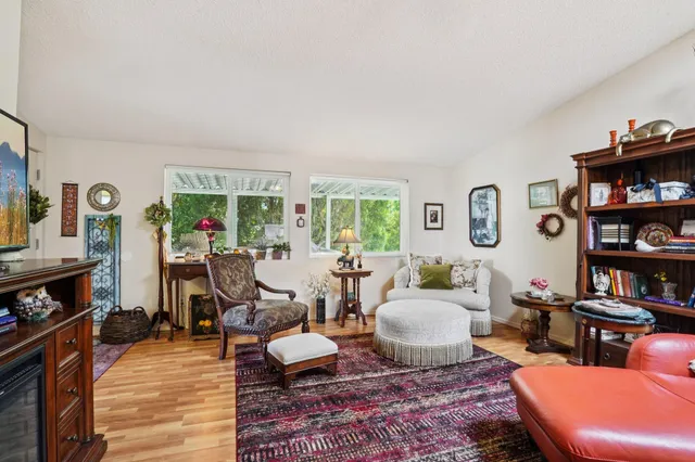 a living room with furniture and a book shelf