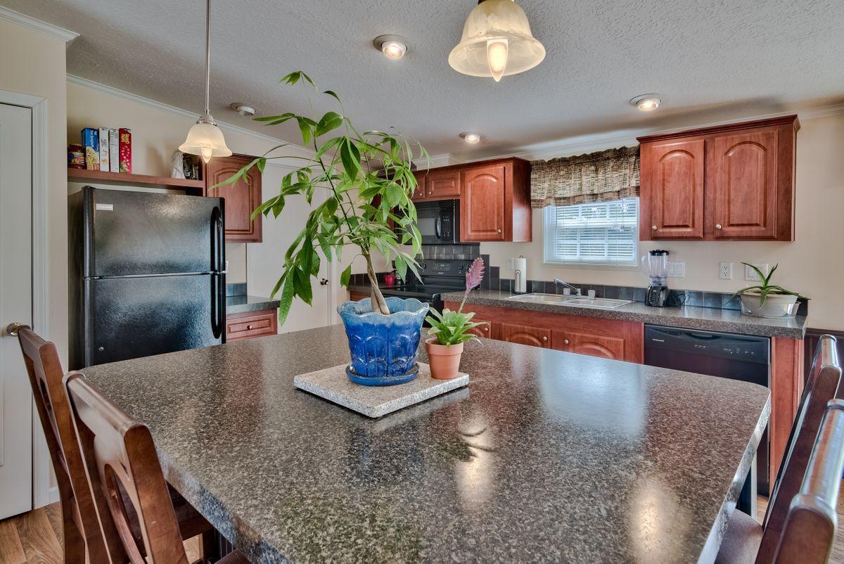 332 Don Graff Road Freeport, FL 32439 - Photo 15 of 33 a kitchen with a refrigerator a stove and cabinets