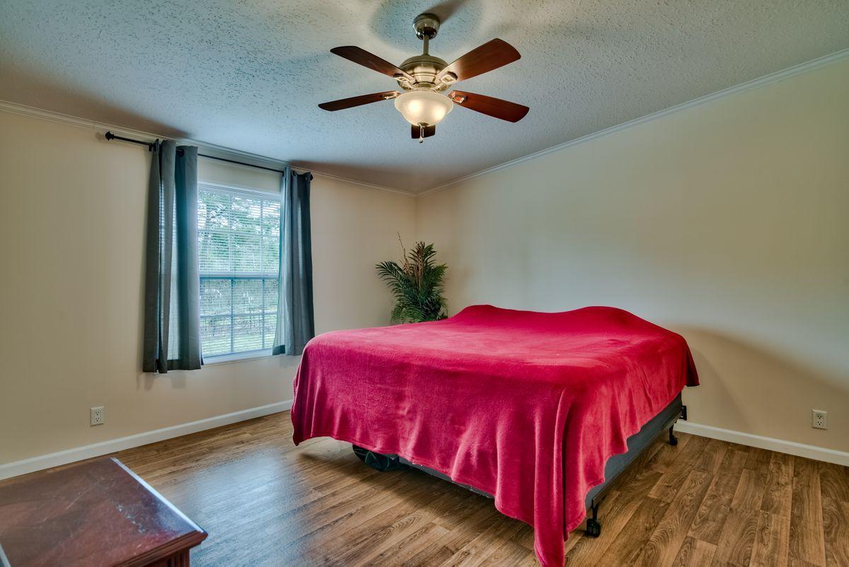 332 Don Graff Road Freeport, FL 32439 - Photo 16 of 33 a bed sitting in a bedroom next to a window