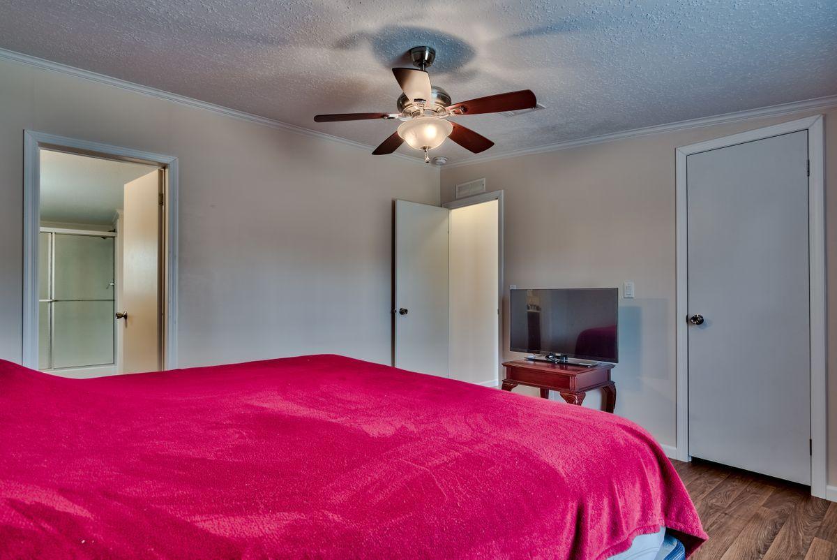 332 Don Graff Road Freeport, FL 32439 - Photo 17 of 33 a bed room with a bed and a flat screen tv