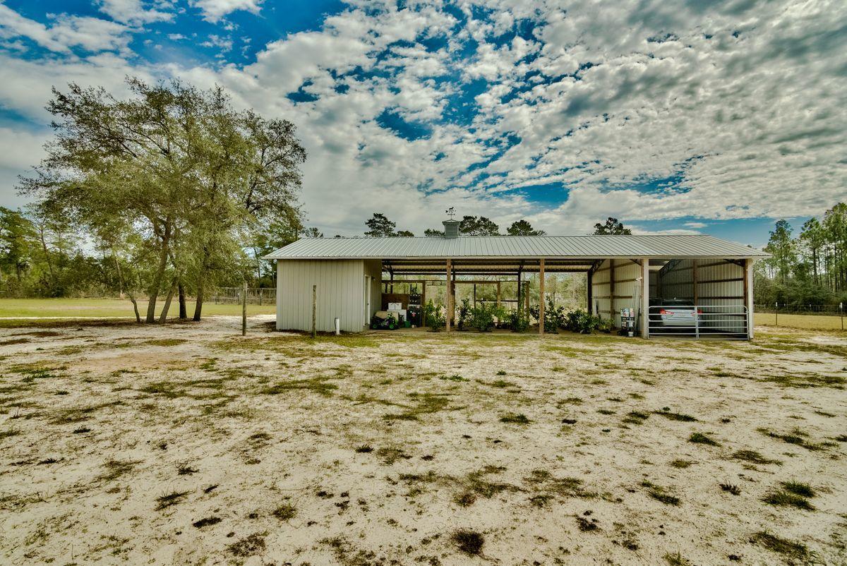332 Don Graff Road Freeport, FL 32439 - Photo 28 of 33 a front view of a house with a garden