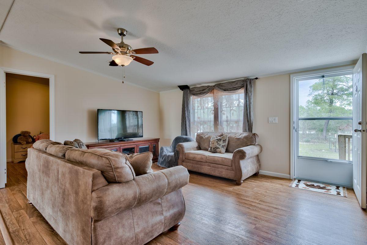 332 Don Graff Road Freeport, FL 32439 - Photo 8 of 33 a living room with furniture and a flat screen tv