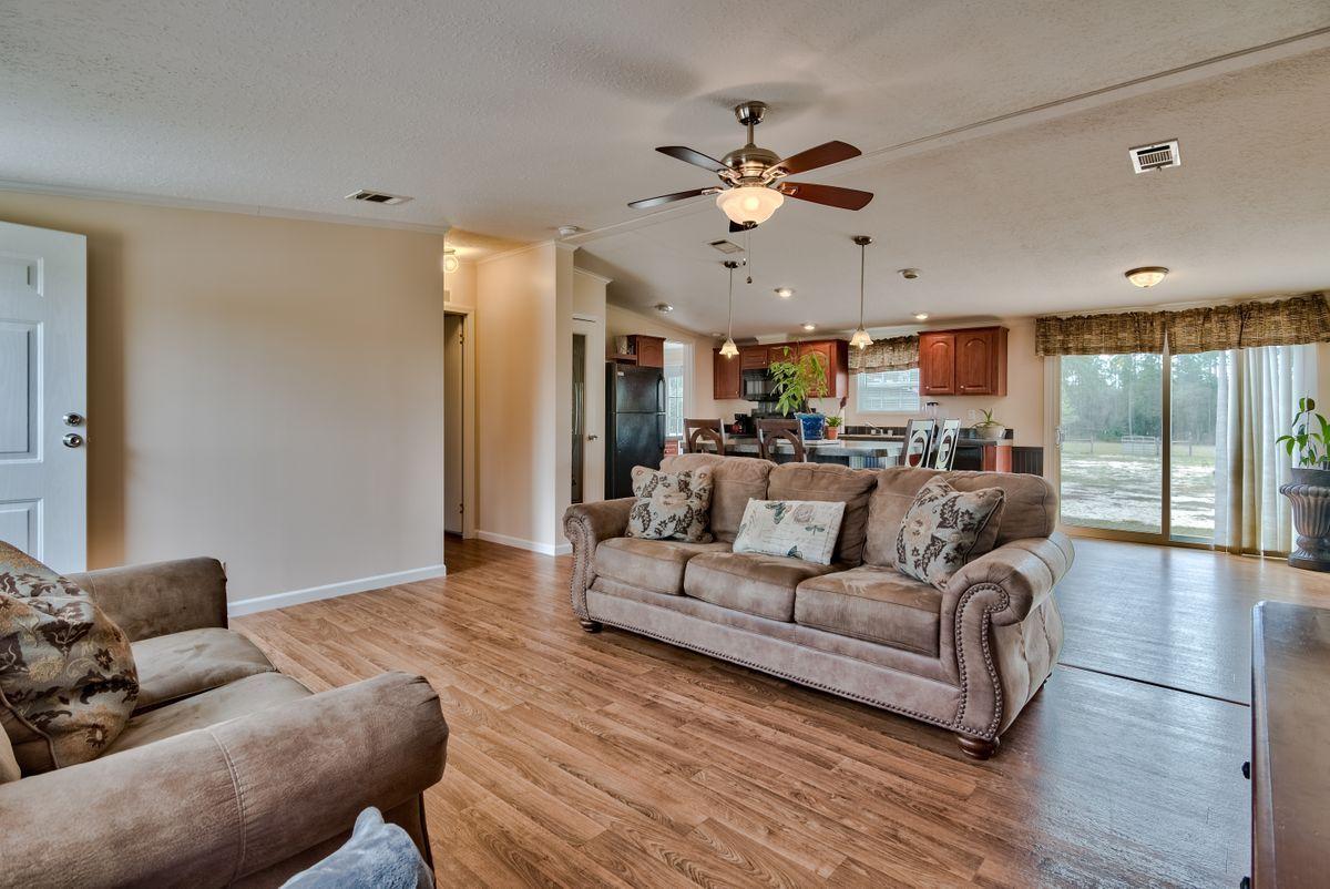 332 Don Graff Road Freeport, FL 32439 - Photo 10 of 33 a living room with furniture and a large window