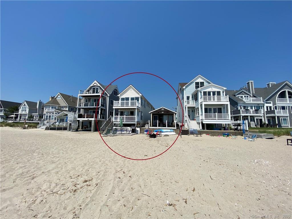 a view of house with yard and ocean view