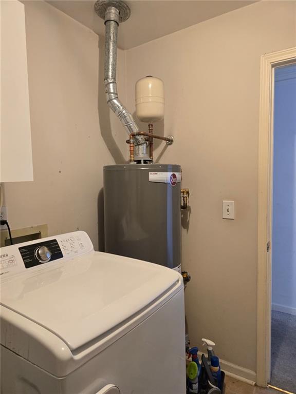 232 Spalding Gates Drive Northeast Atlanta, GA 30328 - Photo 11 of 12 a bedroom with a bed and a chandelier