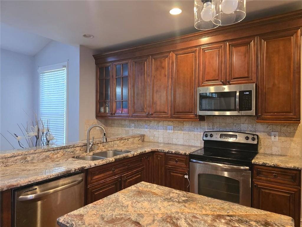 232 Spalding Gates Drive Northeast Atlanta, GA 30328 - Photo 5 of 12 a kitchen with a sink stove and microwave