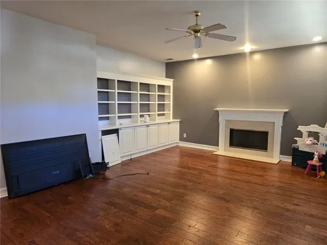 a view of an empty room with a fireplace and a window
