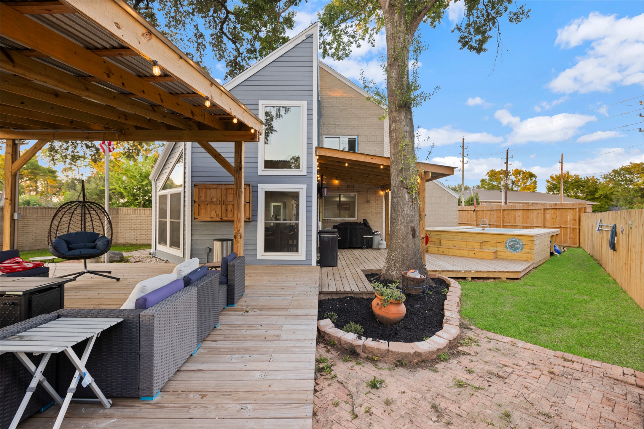 1824 Pine Cone Katy, TX 77493 - Photo 37 of 50 a view of a patio with table and chairs potted plants with wooden floor and fence