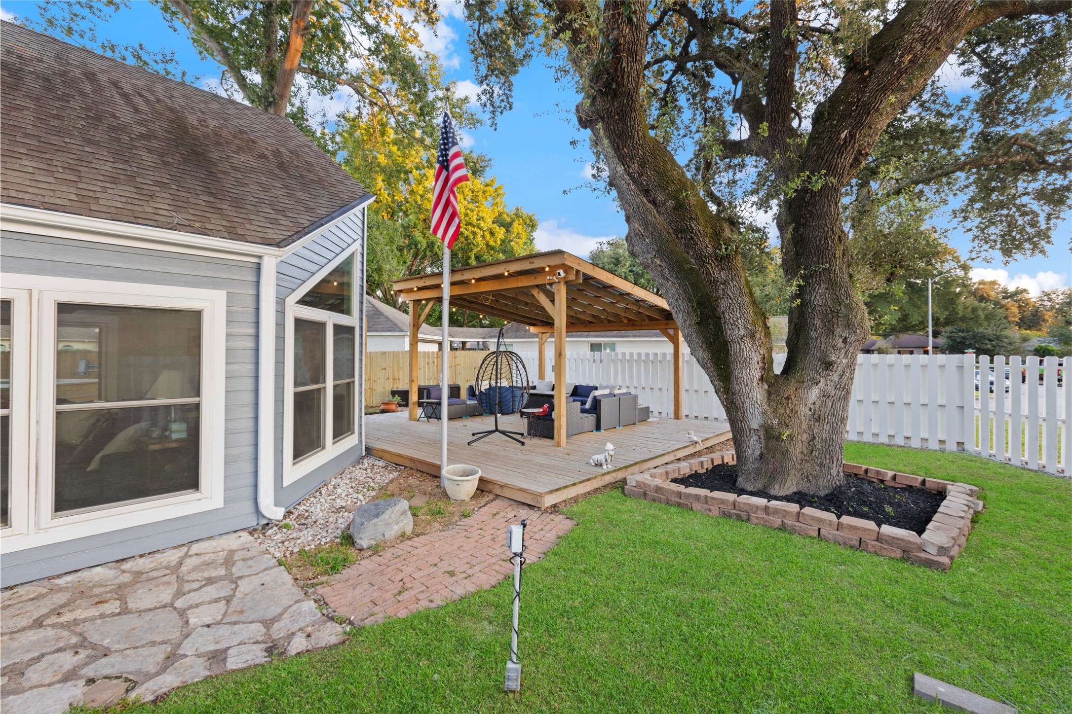 1824 Pine Cone Katy, TX 77493 - Photo 38 of 50 a view of a patio with table and chairs under an umbrella