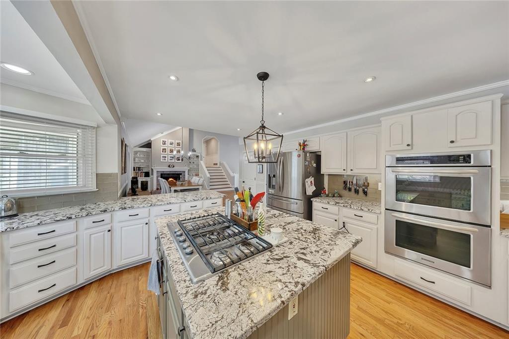 2133 Mann Road Douglasville, GA 30134 - Photo 26 of 69 a kitchen with stainless steel appliances kitchen island granite countertop a stove and a sink