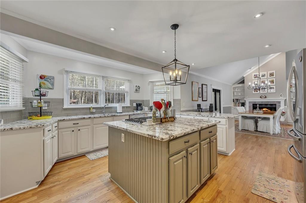 2133 Mann Road Douglasville, GA 30134 - Photo 27 of 69 a kitchen with stainless steel appliances granite countertop a sink dishwasher a stove and white cabinets with wooden floor