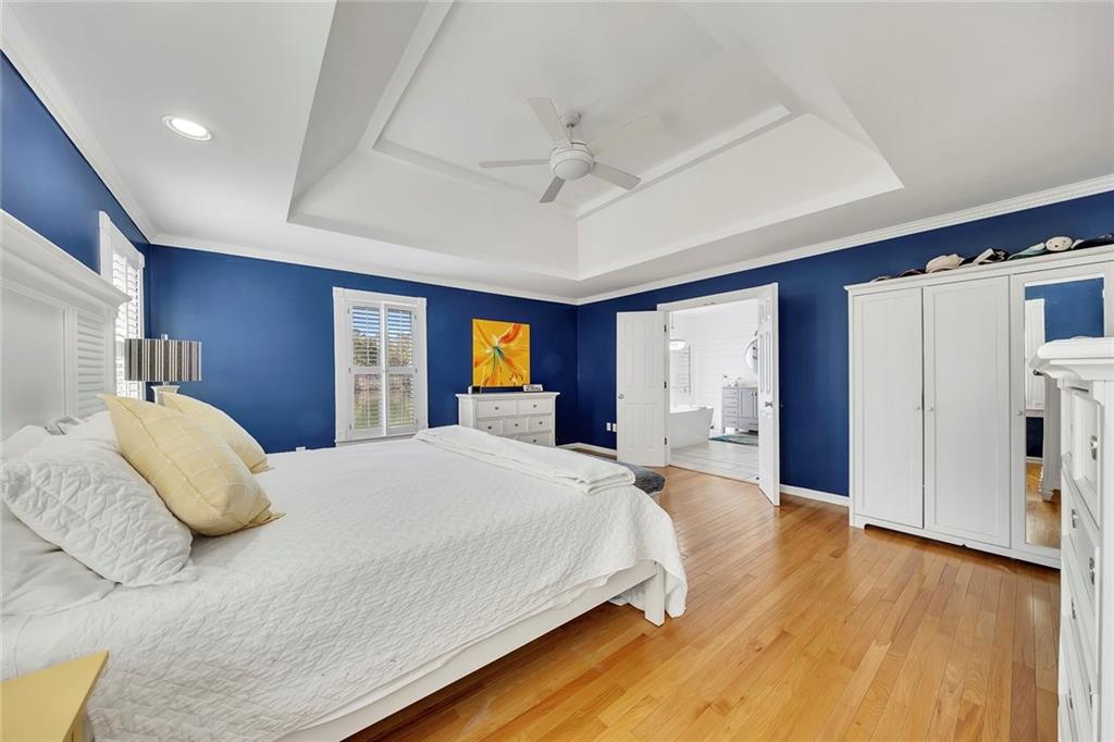 2133 Mann Road Douglasville, GA 30134 - Photo 33 of 69 a spacious bedroom with a large bed and a chandelier