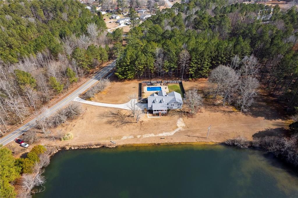 2133 Mann Road Douglasville, GA 30134 - Photo 5 of 69 a backyard of a house with lots of green space and lake view