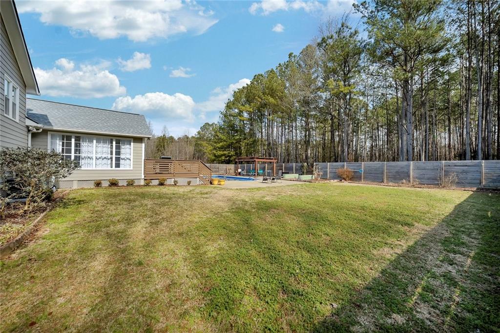 2133 Mann Road Douglasville, GA 30134 - Photo 58 of 69 a swimming pool with outdoor seating and yard