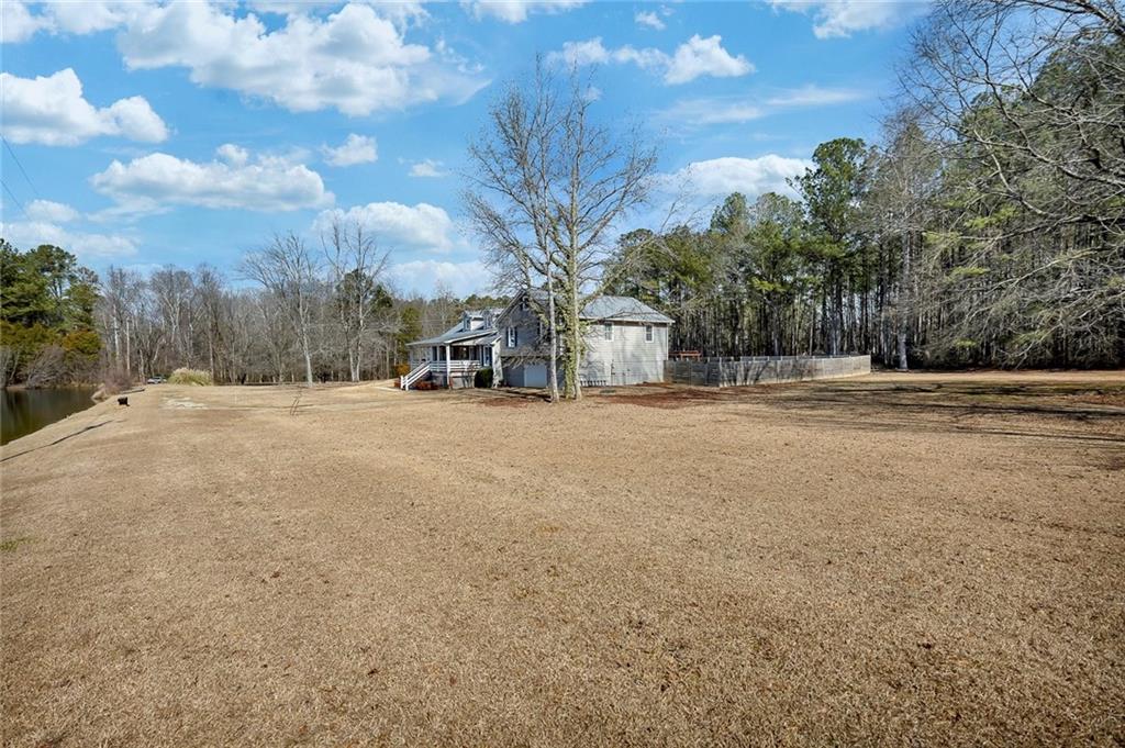 2133 Mann Road Douglasville, GA 30134 - Photo 6 of 69 a view of dirt field with trees in the background