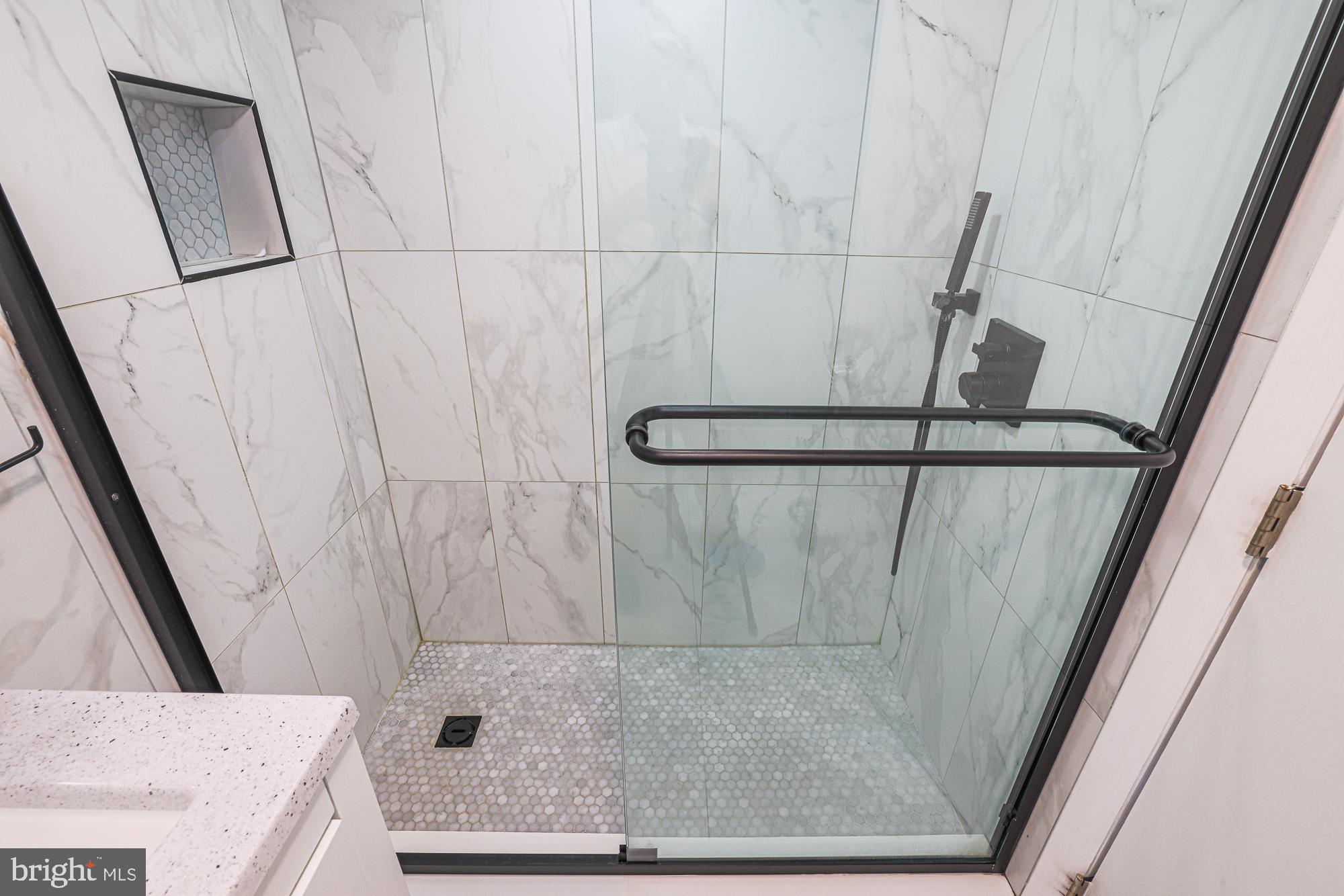 3305 Bancroft Road Baltimore, MD 21215 - Photo 44 of 61 Sleek modern shower with elegant tiles.