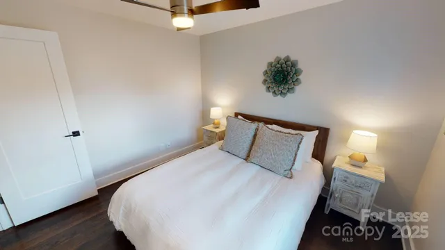 a bedroom with a bed and a night stand