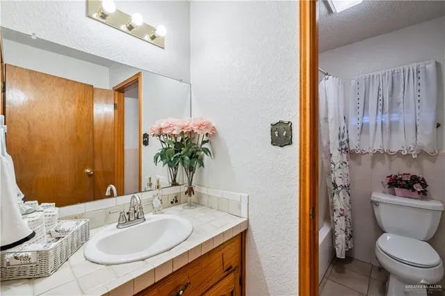 a bathroom with a toilet a sink and bathtub