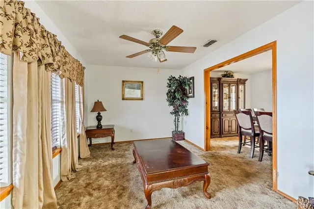 a dining room with furniture a chandelier and window