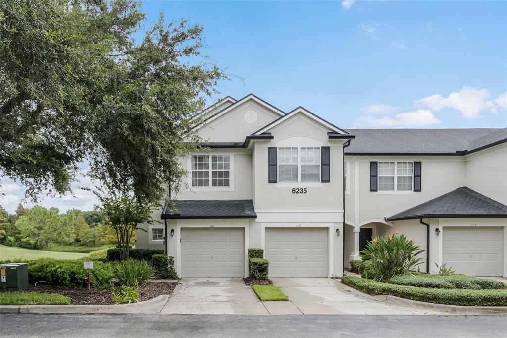 6235 Goethe Street, Unit 101 Orlando, FL 32835 - Photo 1 of 1 a front view of a house with a yard and garage