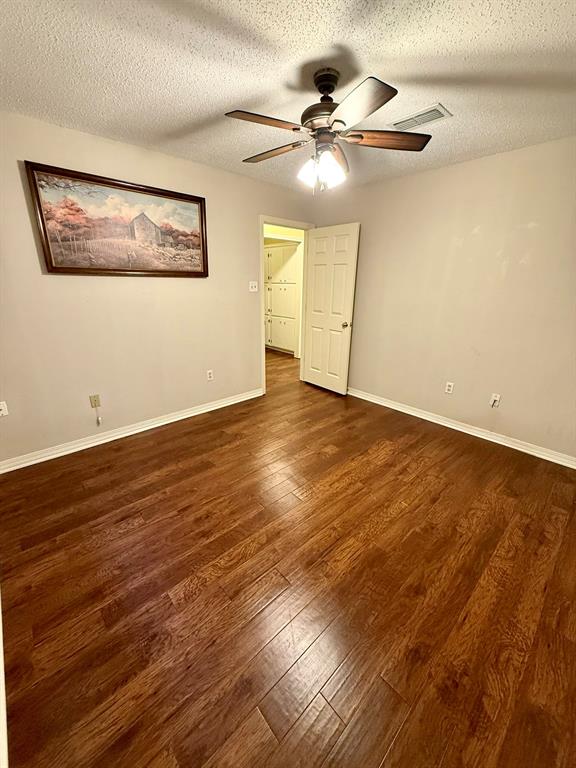 11535 Timber Ridge Drive Keithville, LA 71047 - Photo 11 of 39 an empty room with wooden floor fan and windows