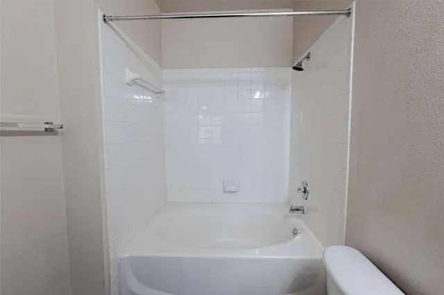 a bathroom with a bathtub and a toilet