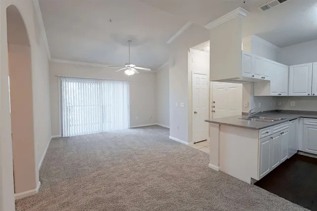 a kitchen with granite countertop white cabinets and white appliances
