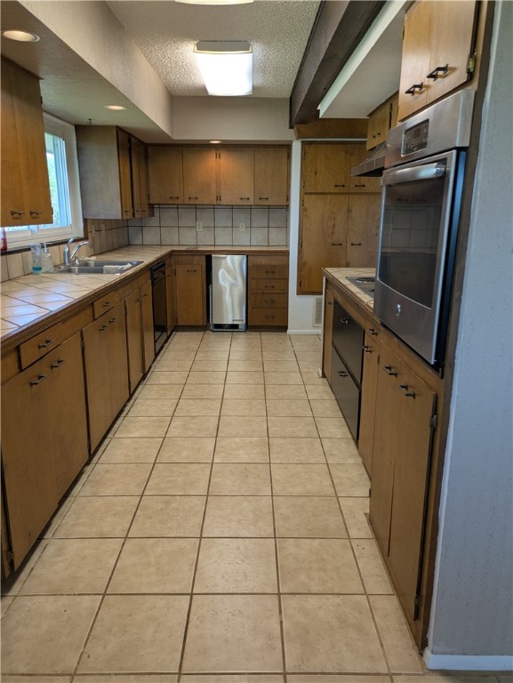 155 Buffalo Road George West, TX 78022 - Photo 18 of 39 a kitchen with stainless steel appliances a sink and cabinets