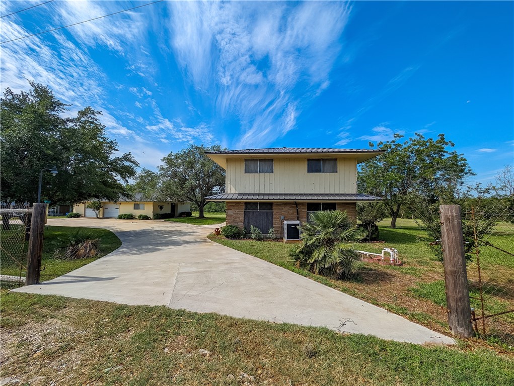 155 Buffalo Road George West, TX 78022 - Photo 3 of 39 a view of house with backyard and trees