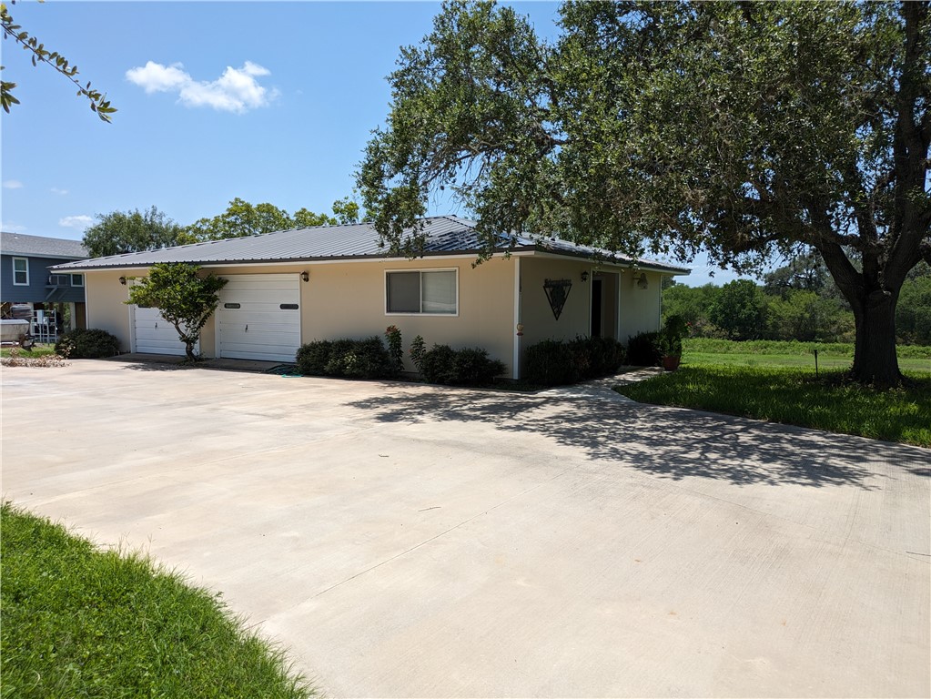 155 Buffalo Road George West, TX 78022 - Photo 8 of 39 a front view of a house with a yard and garage