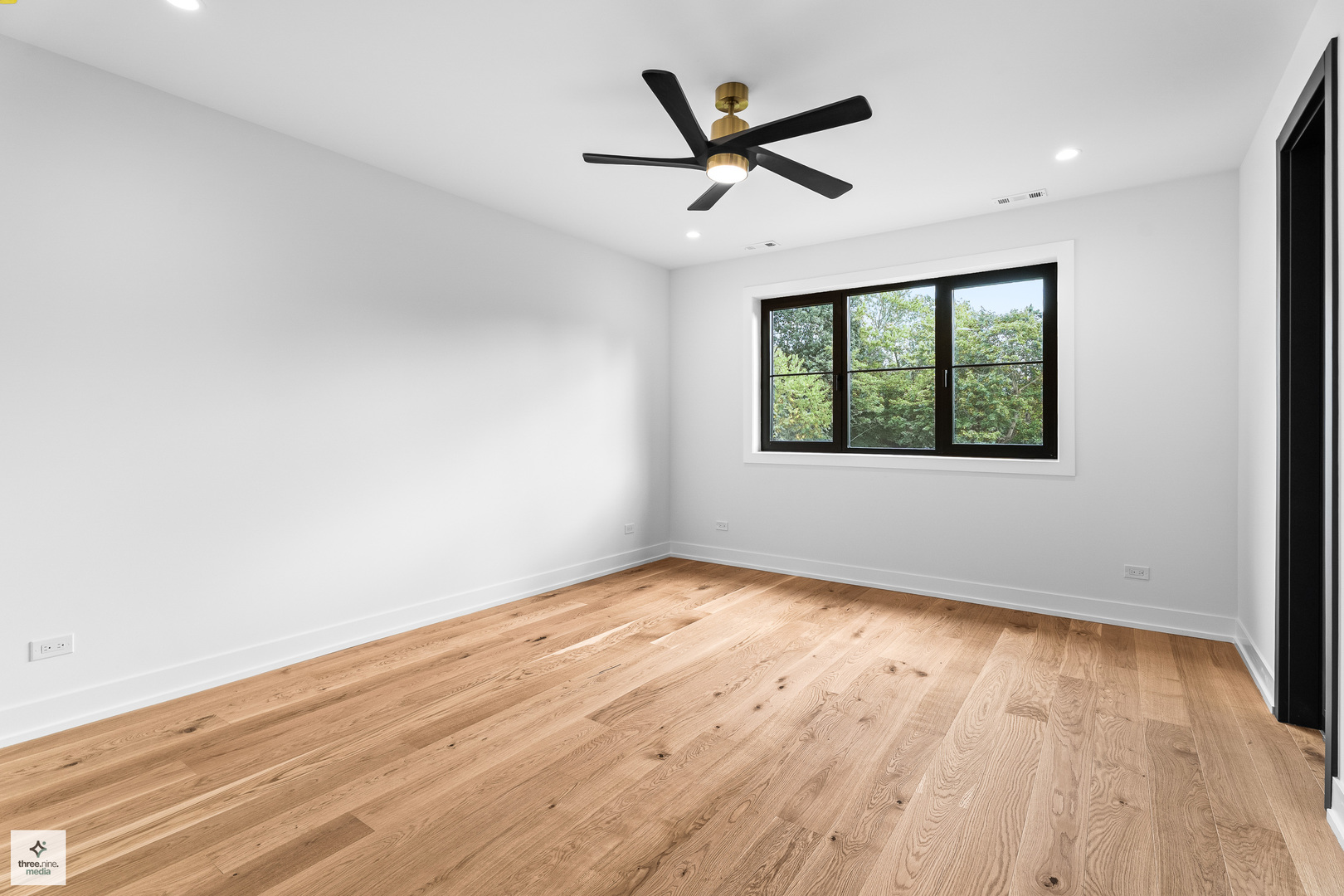 3005 Highland Road Northbrook, IL 60062 - Photo 35 of 68 an empty room with wooden floor ceiling fan and windows