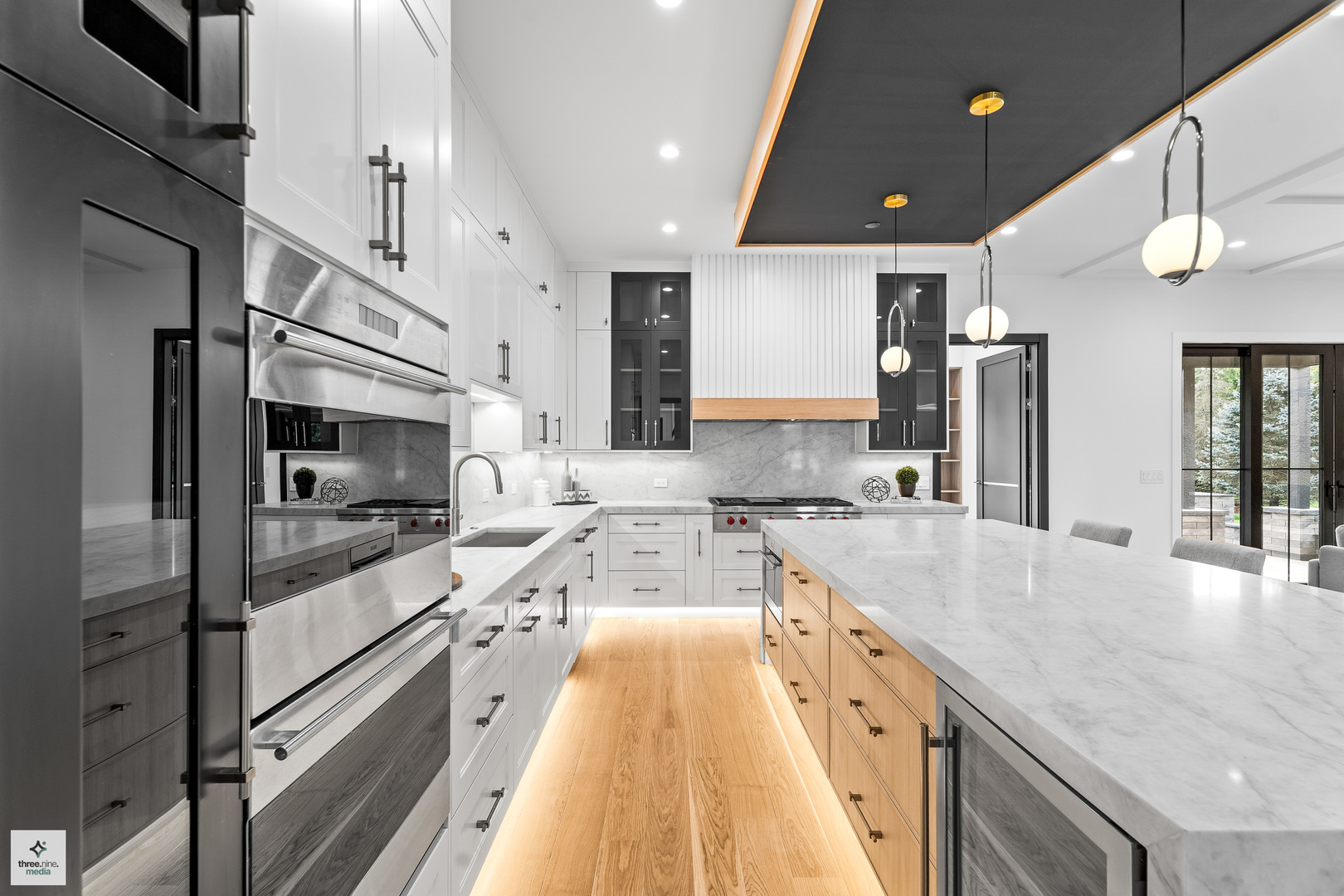 3005 Highland Road Northbrook, IL 60062 - Photo 7 of 68 a large kitchen with stainless steel appliances kitchen island a large counter top a stove a chimney a sink and a refrigerator