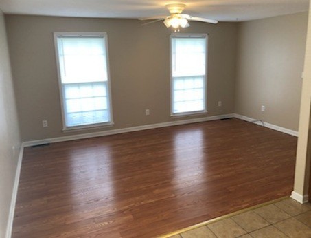 217 Hunter Drive Columbia, TN 38401 - Photo 4 of 7 an empty room with wooden floor and windows
