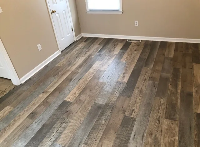 a view of an empty room and wooden floor
