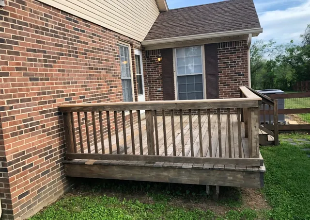 a view of a wooden house with a yard