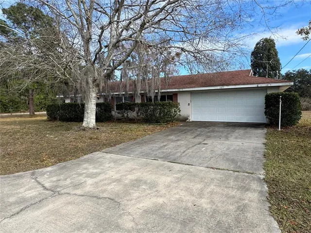 a view of a house with a yard and garage