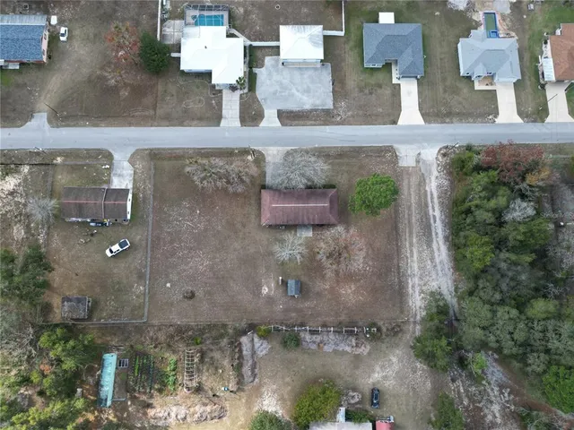 an aerial view of a house with a yard and a fountain