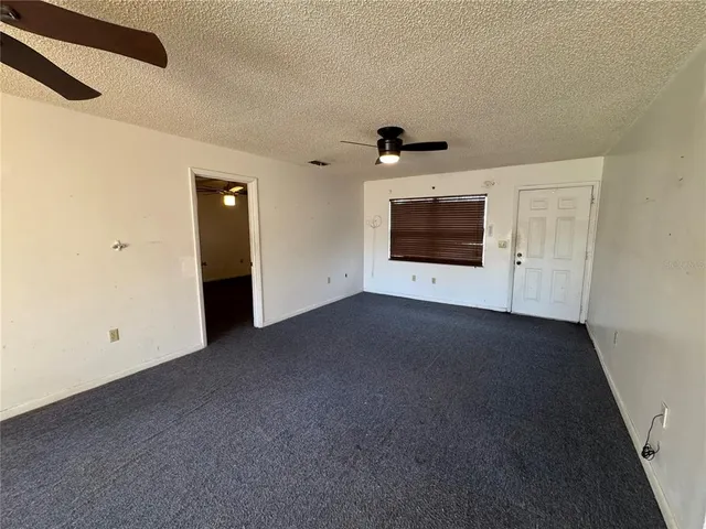 a view of empty room with a fireplace