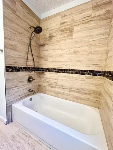 a bathroom with a bathtub and shower