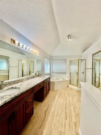 a large bathroom with a large tub and sink