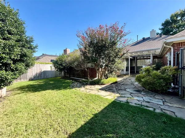 a view of backyard of house with green space