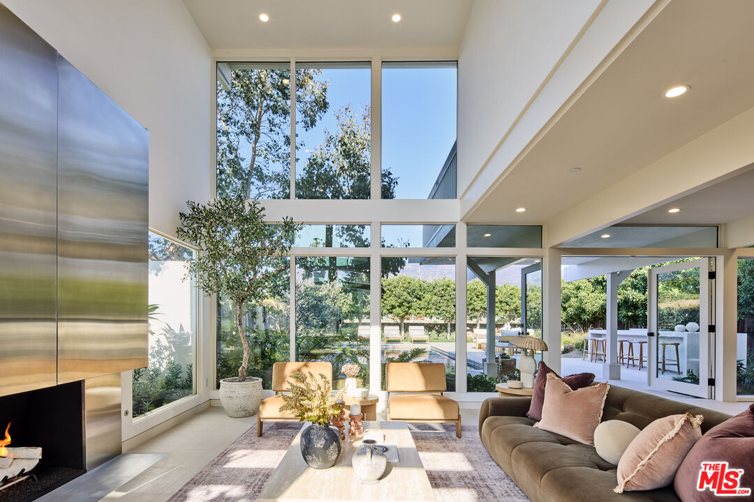a living room with furniture and a floor to ceiling window