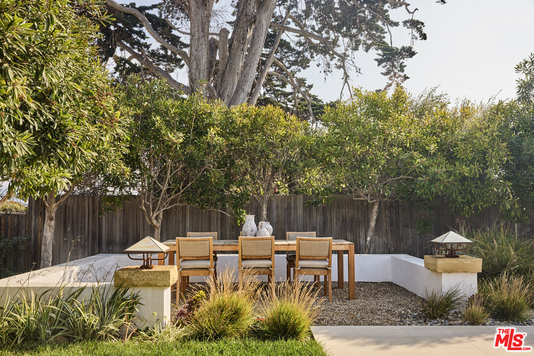 23515 Malibu Colony Road Malibu, CA 90265 - Photo 15 of 22 a backyard of a house with table and chairs