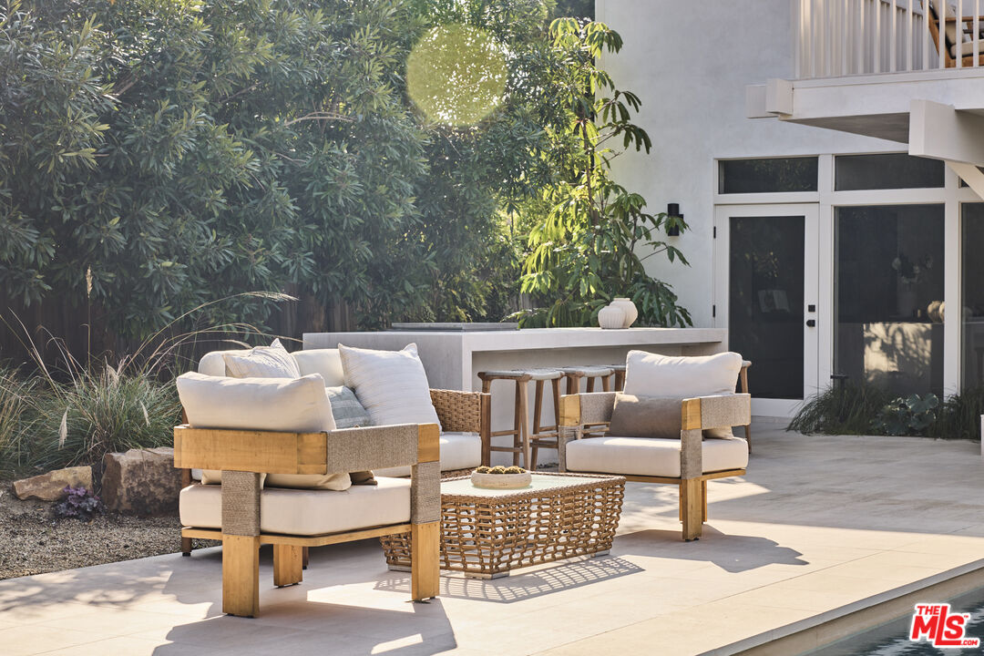 23515 Malibu Colony Road Malibu, CA 90265 - Photo 16 of 22 a roof deck with table and chairs and potted plants