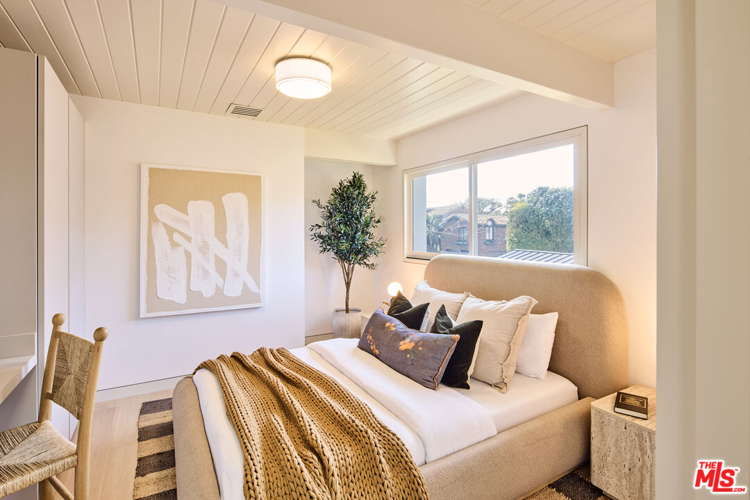 23515 Malibu Colony Road Malibu, CA 90265 - Photo 21 of 22 a bedroom with a bed and a painting on the wall