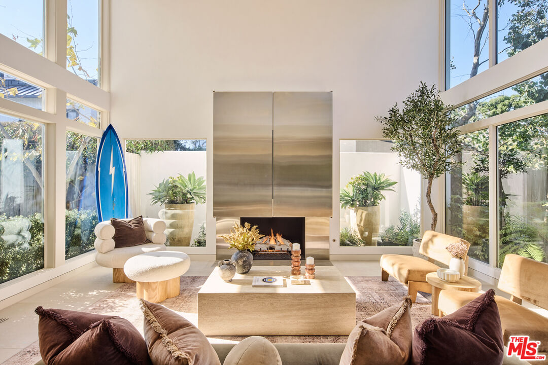 23515 Malibu Colony Road Malibu, CA 90265 - Photo 5 of 22 a living room with furniture fireplace and a large window