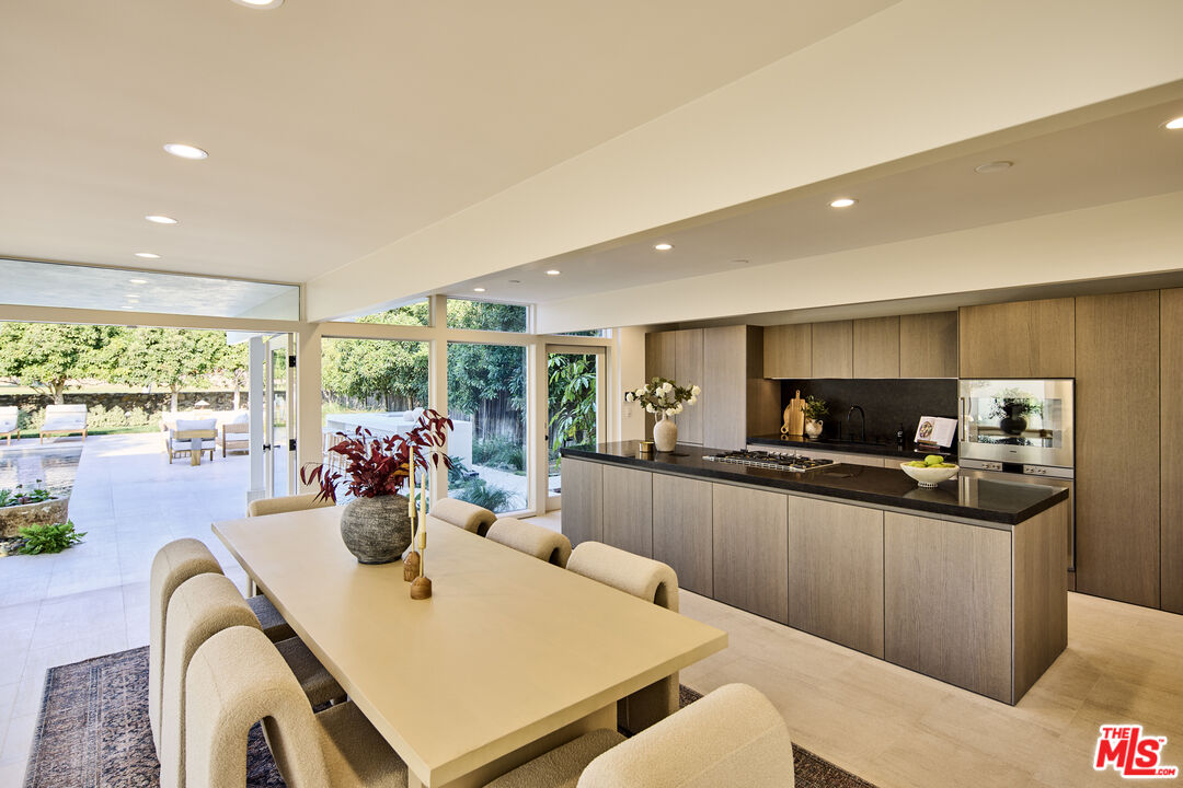 23515 Malibu Colony Road Malibu, CA 90265 - Photo 6 of 22 a kitchen with a table chairs stove and kitchen view