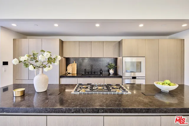 a kitchen with a stove and a granite counter top
